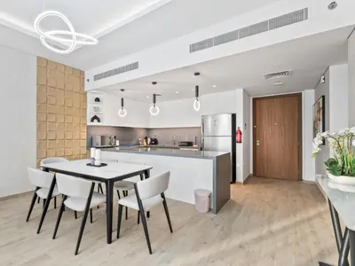 a kitchen and dining room with a table and chairs at Modern Serenity Central Park 2BR Escape-51 in Dubai