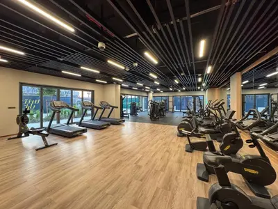 a gym with treadmills and elliptical machines at Modern Serenity Central Park 2BR Escape-51 in Dubai