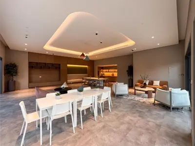 a large room with a table and chairs and a couch at Modern Serenity Central Park 2BR Escape-51 in Dubai
