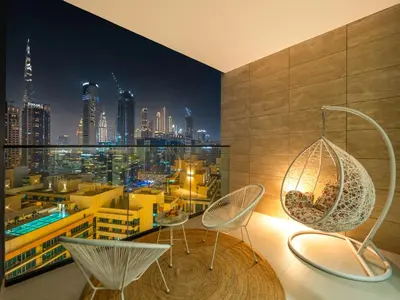 a room with a view of a city at night at Premium Burj Khalifa View & Private Jacuzzi in Dubai