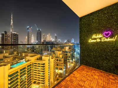 a room with a view of a city at night at Premium Burj Khalifa View & Private Jacuzzi in Dubai