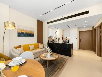 a living room with a couch and a table at Premium Burj Khalifa View & Private Jacuzzi in Dubai
