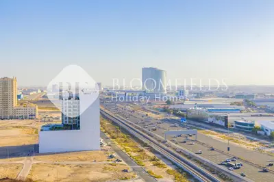 an aerial view of a city with a highway at Bloomfields Cozy Stu in Alexis Tower in Dubai