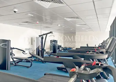 a gym with a bunch of tread machines in it at Bloomfields Cozy Stu in Alexis Tower in Dubai