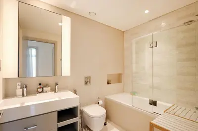 a bathroom with a sink and a toilet and a shower at Livbnb - Chic 1BR, Beachfront & Marina Views in Dubai
