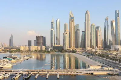 a view of a large city with boats in the water at Livbnb - Chic 1BR, Beachfront & Marina Views in Dubai