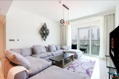 a living room with a couch and a table at Livbnb - Chic 1BR, Beachfront & Marina Views in Dubai