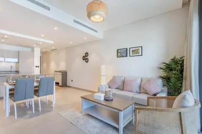 a living room with a couch and a table at STAY BY LATINEM Luxury 1BR Holiday Home WG2809 Near Burj Khalifa in Dubai