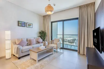 a living room with a couch and a large window at STAY BY LATINEM Luxury 1BR Holiday Home WG2809 Near Burj Khalifa in Dubai