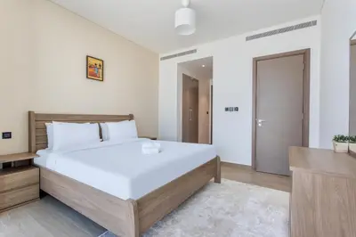 a bedroom with a large white bed in a room at STAY BY LATINEM Luxury 1BR Holiday Home WG2809 Near Burj Khalifa in Dubai