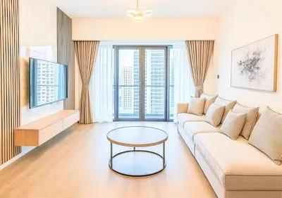 a living room with a couch and a table at DreamShoma- Super Spacious 1BR Lake View in Dubai