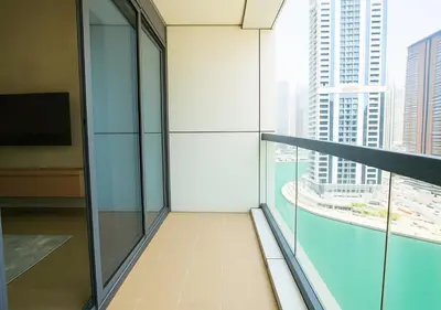 an office building with a view of a city at DreamShoma- Super Spacious 1BR Lake View in Dubai
