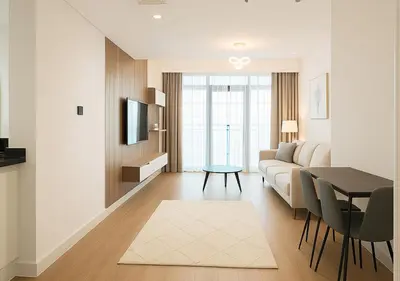 a living room with a couch and a table at DreamShoma- Super Spacious 1BR Lake View in Dubai