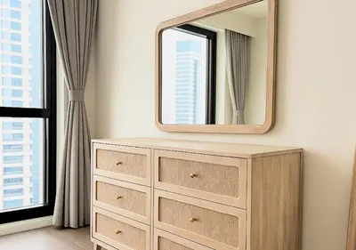 a dresser with a mirror on top of it at DreamShoma- Super Spacious 1BR Lake View in Dubai