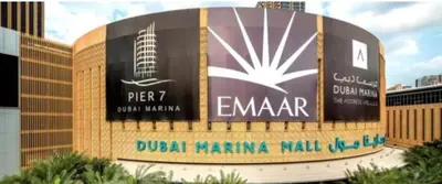 a sign in front of a building with a microphone at Diamond Marina Inn, Heart of Marina in Dubai