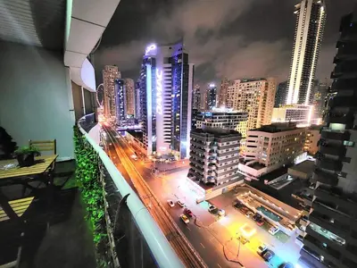 a view of a city at night with traffic at Diamond Marina Inn, Heart of Marina in Dubai