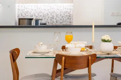 a dining room table with a candle and wine glasses at Sky-High Infinity Pool with Burj Khalifa Views in Dubai