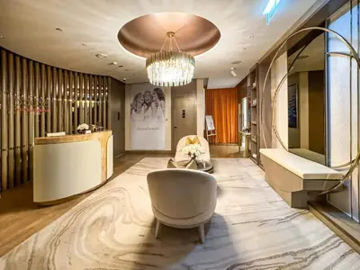 a living room with a couch and a chandelier at Sky-High Infinity Pool with Burj Khalifa Views in Dubai