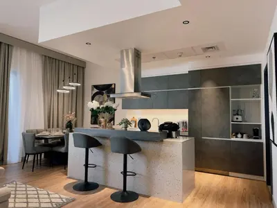 a kitchen with a counter and a table with chairs at Elite Turnkey Residence 2BR in OIA Motor City 237 Dubai in Dubai