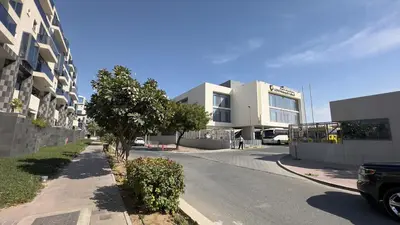 a street in front of a large white building at Elite Turnkey Residence 2BR in OIA Motor City 237 Dubai in Dubai