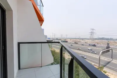 a balcony with a view of a highway at 1 Bedroom in JVC in Dubai