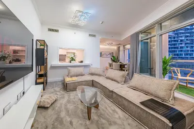 a living room with a couch and a large window at & Burj Luxury Living 2bhk Direct Burj Khalifa View in Dubai