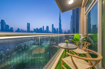 a balcony with a table and chairs and a view of the city at & Burj Luxury Living 2bhk Direct Burj Khalifa View in Dubai