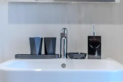 a white sink with various items on top of it at TRPS - Peninsula Five, Business Bay - Stylish 1BR - Canal & Burj Khalifa Views in Dubai