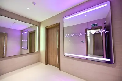 a room with a hallway with a door and mirrors at Spacious 1 BHK with City Views Near Burj Khalifa in Dubai
