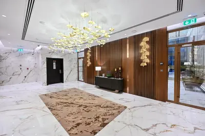 a lobby with a large marble floor and a chandelier at Spacious 1 BHK with City Views Near Burj Khalifa in Dubai