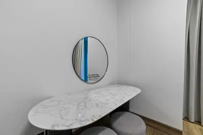 a table with a mirror on a wall at Modern Apartment with Canal Views, Near Dubai Mall and Burj Khalifa in Dubai