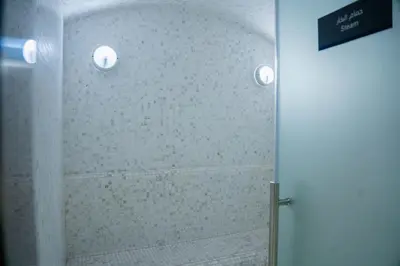 a shower with a glass door in a bathroom at Modern Apartment with Canal Views, Near Dubai Mall and Burj Khalifa in Dubai