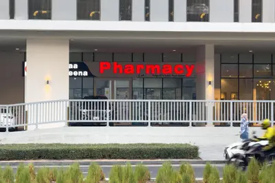 a pharmacy sign in front of a building at Modern Apartment with Canal Views, Near Dubai Mall and Burj Khalifa in Dubai