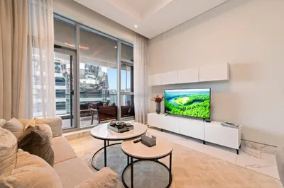 a living room with a couch and a tv at Modern Apartment with Canal Views, Near Dubai Mall and Burj Khalifa in Dubai