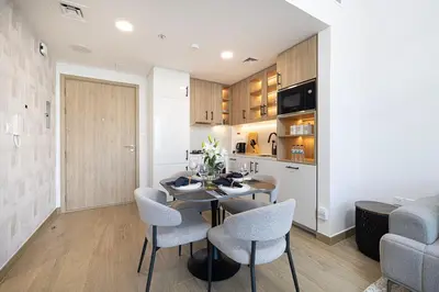 a kitchen and dining room with a table and chairs at The Gifted Cozy Home in Dubai