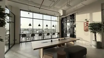 a room with a table and chairs and a large window at The Gifted Cozy Home in Dubai