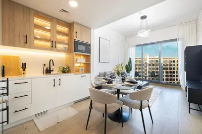 a kitchen and dining room with a table and chairs at The Gifted Cozy Home in Dubai