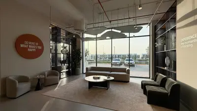 a lobby with a couch and chairs and a table at The Gifted Cozy Home in Dubai