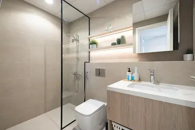 a bathroom with a shower and a toilet and a sink at The Gifted Cozy Home in Dubai