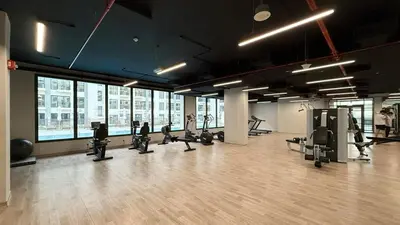 a gym with treadmills and ellipticals in a building at The Gifted Cozy Home in Dubai