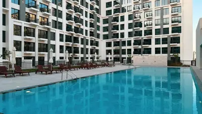 a large swimming pool in front of a building at The Queens Tranquil Oasis 1BDR in Dubai