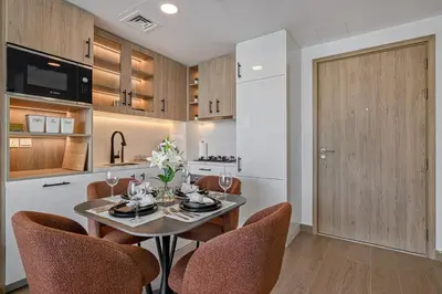 a kitchen and dining room with a table and chairs at The Queens Tranquil Oasis 1BDR in Dubai