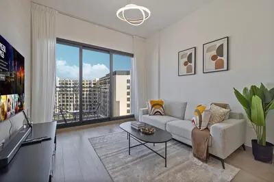 a living room with a couch and a large window at The Queens Tranquil Oasis 1BDR in Dubai
