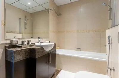 a bathroom with a sink and a bath tub at AWS Holiday Homes - Comfort and Marina Views in Dubai
