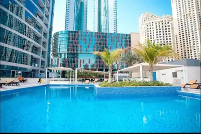 a large swimming pool in a city with tall buildings at AWS Holiday Homes - Comfort and Marina Views in Dubai