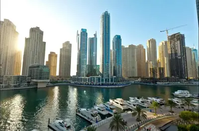 a view of a city with boats in a harbor at AWS Holiday Homes - Comfort and Marina Views in Dubai