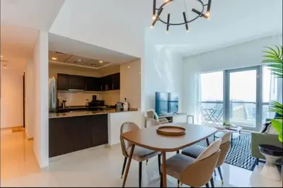 a kitchen and dining room with a table and chairs at AWS Holiday Homes - Comfort and Marina Views in Dubai