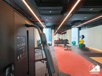 a gym with cardio equipment in the middle of a room at Modern 2B Apartment with Pool Acess SOBHA CREEK in Dubai