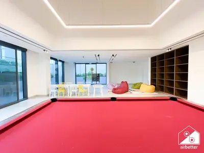a living room with a red pool table at Modern 2B Apartment with Pool Acess SOBHA CREEK in Dubai