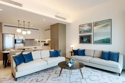 a living room with two couches and a table at Livbnb - Premium 3BR with Burj Skyline View in Dubai